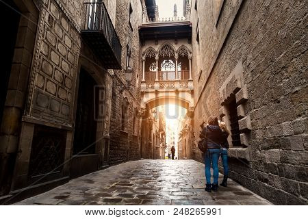 Woman Tourist Sightseeing In Barcelona Barri Gothic Quarter And Bridge Of Sighs In Barcelona, Catalo