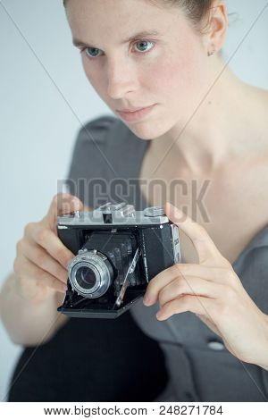 Young Woman Using A Vintage Zeiss Film Camera