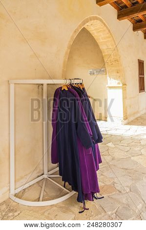Omodos, Cyprus. May 2018. A Typical View Of Traditional Religious Clothing Hanging Outside The Timio