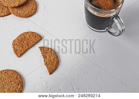 Healthy Snack Concept - Wholegrain Oat Unsweetened Cookies And Plain Black Coffee On A Textured Whit