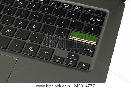 Flag Of Chechen Republic Of Ichkeria On Laptop Keyboard, Close-up.