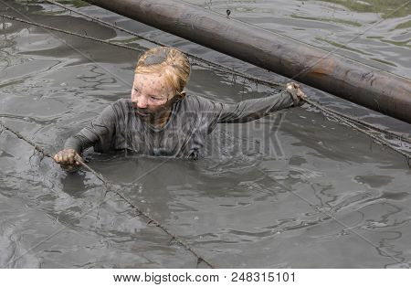 Biddinghuizen, The Netherlands - June 23, 2018: Child During A Mud Run (mudraise, Charity) In The Mu