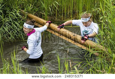 Biddinghuizen, The Netherlands - June 23, 2018: Girls During A Mud Run (mudraise, Charity) In The Mu