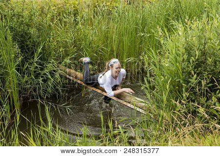 Biddinghuizen, The Netherlands - June 23, 2018: Girl During A Mud Run (mudraise, Charity) In The Mud