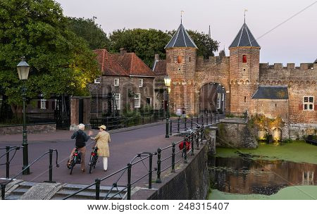 Amersfoort, The Netherlands - June 28, 2018: Koppelpoort In The Evening With Some People At The Old 