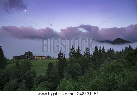Photo Of Misty Morning Fog At The Sunrise In The Mountains. Ukraine, Carpathians, Dzembronia Village