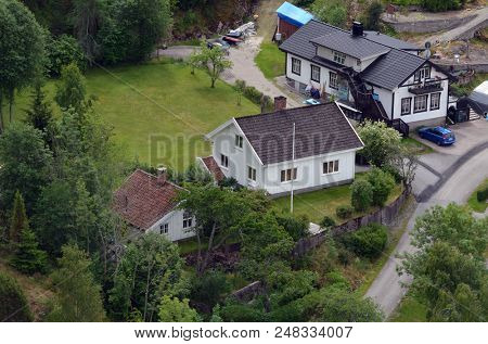 Typical Swedish nature and houses on the shore of the fjord. View from the high bridge over the fjord. The border of Norway and Sweden.June 18,2018.Near the town Selater,Sweden