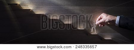 Wide Panorama Image Of A Businessman Climbing The Corporate Ladder Towards The Light Using Paper Cut