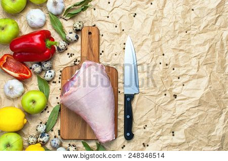 Raw Turkey Thigh Garlic Apples Lemon Red Bell Pepper Quail Eggs Spices On A Wooden Board. Top View O