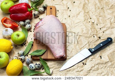 Raw Turkey Thigh Garlic Apples Lemon Red Bell Pepper Quail Eggs Spices On A Wooden Board. Top View O