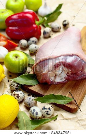 Raw Turkey Thigh Garlic Apples Lemon Red Bell Pepper Quail Eggs Spices On A Wooden Board. Top View O