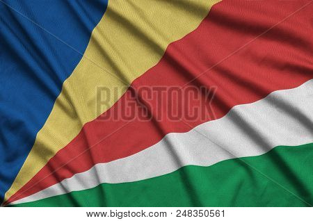 Seychelles Flag  Is Depicted On A Sports Cloth Fabric With Many Folds. Sport Team Waving Banner