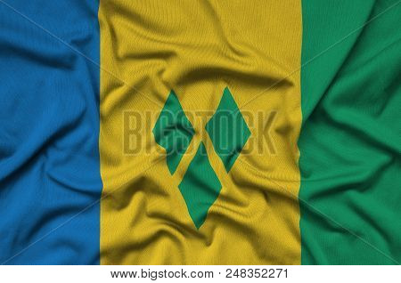 Saint Vincent And The Grenadines Flag  Is Depicted On A Sports Cloth Fabric With Many Folds. Sport T