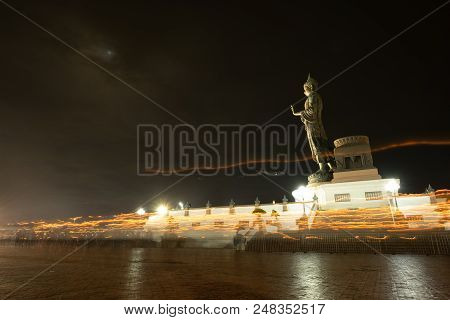 Beautiful Milky Way And Big Buddha Statue At Night And Moving Candle Light In Makha Bucha Day.