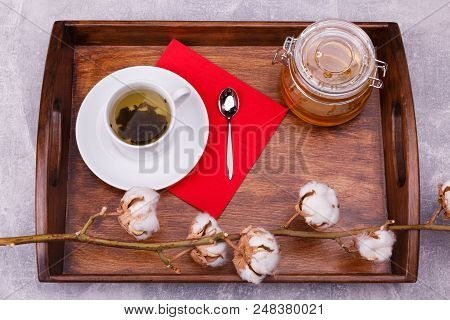 A Wooden Tray With Cutlery For Drinking Tea Consists Of A Saucer With A Cup Teaspoon Napkin Glass Po