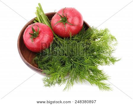 Ripe Tomatoes With Fresh Dill Are Arranged On The Rural Wooden Plate, Situated On The White Backgrou