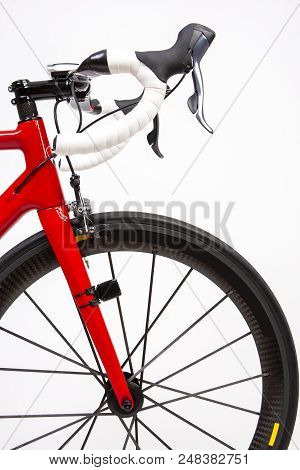Partial View Of Professional Carbon Road Bike On Deep Profile Carbon Aero Wheels. Over White. Vertic