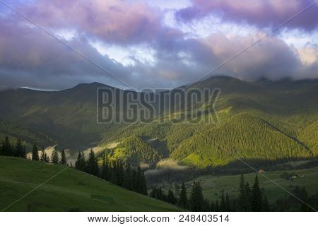 Photo Of Mountain Landscape In The Summer Under Beautiful Cloudy Sky. Ukraine, Carpathians, Dzembron