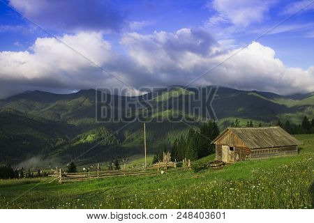Photo Of Mountain Village In The Summer Under Beautiful Cloudy Sky. Ukraine, Carpathians, Dzembronia