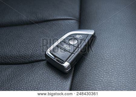 Closeup Inside Vehicle Of Wireless Key Ignition. Start Engine Key. Car Key Remote In Black Perforate