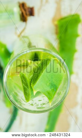 Aloe Vera Extract In A Small Bottle And Pieces On The Table. Selective Focus.