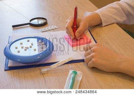 Shot Of Female Medical Doctor's Hands. Doctor Working For Medical Exam