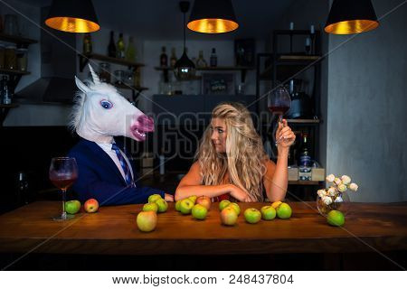 Unusual Couple Spend Time Together At The Bar Counter In Stylish Apartments With Wine And Food. Beau