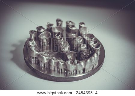 Object Printed On Metal 3d Printer. Dental Crowns Created In A Laser Sintering Machine Close-up. Dml