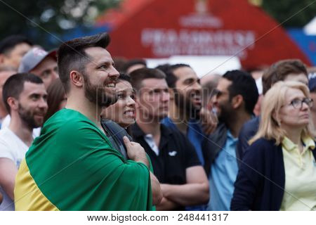 ST. PETERSBURG, RUSSIA - JUNE 17, 2018: Football fans watch the game at FIFA Fan Fest in Saint Petersburg during the FIFA World Cup Russia 2018. The city hosts 7 matches of FIFA World Cup