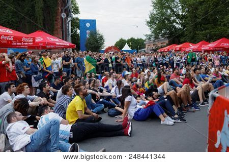 ST. PETERSBURG, RUSSIA - JUNE 17, 2018: Football fans watch the game at FIFA Fan Fest in Saint Petersburg during the FIFA World Cup Russia 2018. The city hosts 7 matches of FIFA World Cup