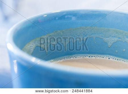 Stain Of Hot Milk Cocoe And Soft Froth Inside The Blue Ceramic Cup, Half A Cup Of Cocoa