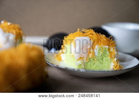 Close Up Selective Focus Piece Of  Gold Egg Yolk Thread Cake, Or Cake Foi Tong Thai Pandan Cake  Wit