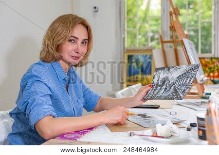 Pretty Smiling Woman Drawing A Picture With Pencil. Front View On Drawing Girl With Pencil In Her Ha