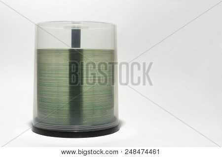 Transparent Rim Of Cds In Stack. Plastic Storage Tube With Blurry Visible Spindel Under Screwed Cove