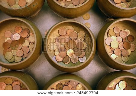 Top View Of Coins In Little Monk Bowl For Exorcise From Believe In Buddhism