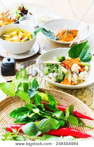 Thai Traditional Cuisine Table. Pad Pak Ruam Mitr Stir Vegetables, Red Curry Chicken In Coconut Milk