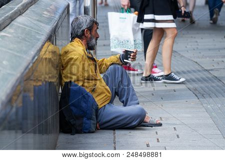Vienna, Austria - July 7, 2018: Male Foreign Beggar Sitting In Shopping Street Of Mariahilfer Strass
