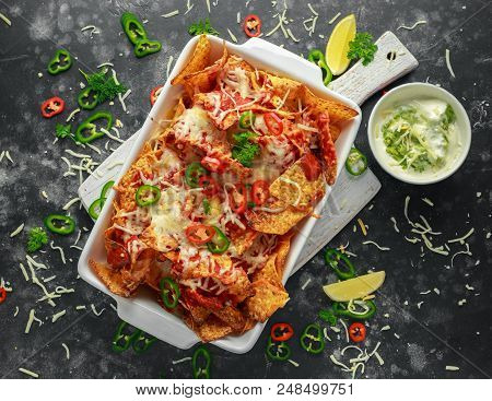 Maxican-style Tortilla Nachos Chips Topped With Tomato Salsa, Sliced Chilies And Melted Cheese Serve