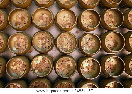 Top view of coins in little monk bowl for exorcise from believe in Buddhism