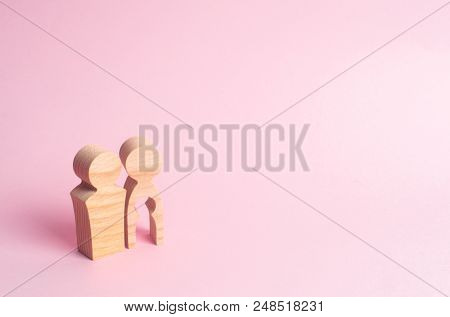 Wooden figures of a man and a woman with a void inside the body in the form of a child. Infertility in a couple. Loss of a single child. Medical problems. The couple wants to have a baby.