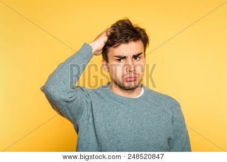 Perplexed Baffled Confused Man Scratching Head And Looking Owlishly At Smth. Portrait Of Handsome Br