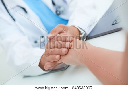 Hand Of Doctor Reassuring Her Female Patient. Medical Ethics And Trust Concept
