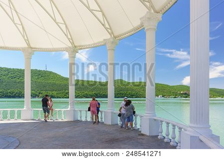 Vacationers On The Waterfront Of The Picturesque Mountain Lake Abrau. Music Scene
