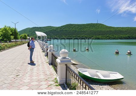 Picturesque Embankment Of The Mountain Lake Abrau. Summer Sunny Day