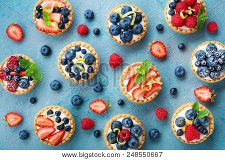 Colorful Berry Tartlets Or Cake For Kitchen Pattern. Pastry Dessert From Above.