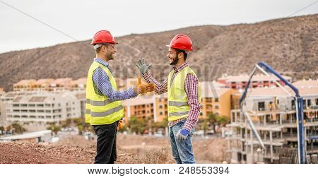 Builders On Residential Construction Site Making A Deal - Happy Workers Are Satisfied Of Their Plan 