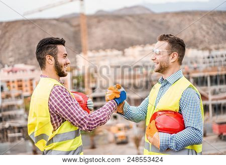 Builders On Residential Construction Site Making A Deal - Happy Workers Are Satisfied Of Their Plan 