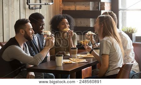 Smiling Multiracial Friends Eating Pizza And Drinking Coffee, Laughing And Having Fun In Restaurant,