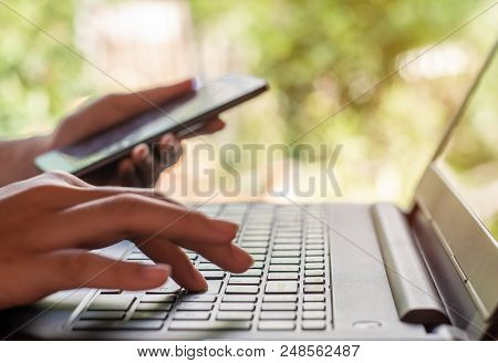 Online Shopping And Online Banking And Internet Banking Concept, Hand With Smart Phone And Laptop On