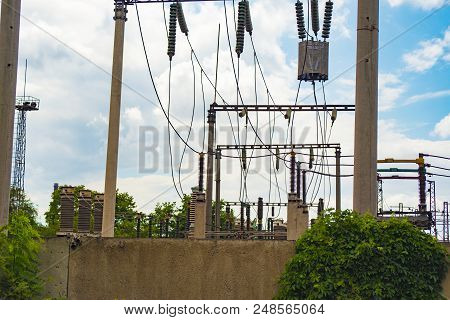 High-voltage Wires On Poles Under High Voltage. Tinted Image. Power Plants On The Industry.
